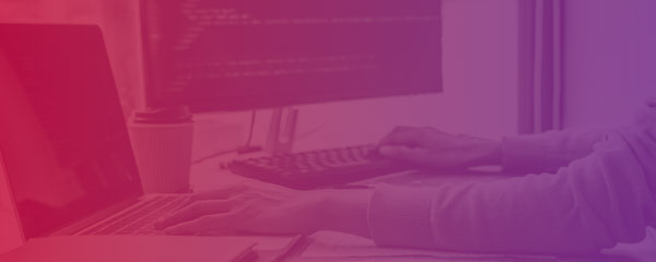 Photo of programmer coding with pink-purple overlaying gradient